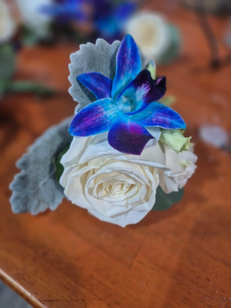 White rose with blue accent pin  - prom and homecoming